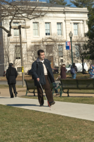 Image of student walking across campus